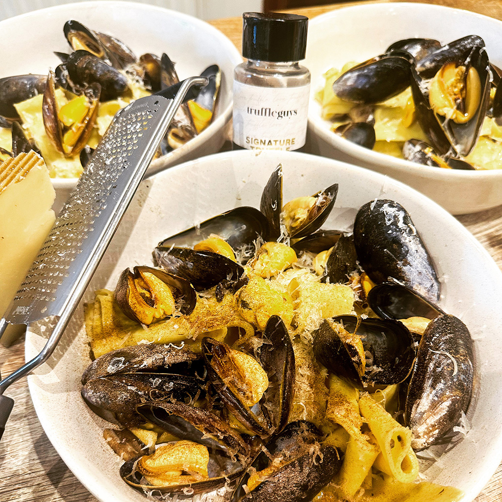 Plated dish of truffle and mussel pasta